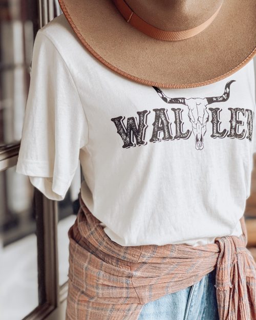 gorgeous outfit from the Only Prettier Design boutique with hat, western t-shirt, jeans, and a button-down long sleeve shirt tied around the waist